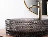 A close-up view of a decorative glass sink with a faucet. Anteprima dell’immagine prodotto