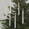 A close-up view of white LED candle lights clipped onto the branches of a Christmas tree. Podgląd zdjęcia produktu