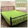 A fitted sheet on a bed with a decorative metal headboard. Produktbild-Vorschau