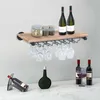 A wine rack with wine bottles and glasses displayed on a shelf and countertop. Voir les images du produit