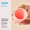 A hand holding a mooncup beginner menstrual cup. You can see inside it's capicity. Suitable for heav Produktbild-Vorschau