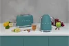 A teal SMEG toaster and kettle are displayed on a white countertop with lemons, cinnamon sticks, and a glass of tea. Anteprima dell’immagine prodotto