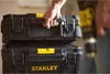 A person is holding two stacked Stanley toolboxes. Voir les images du produit