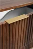 A close-up of a dark brown cabinet drawer with a gold handle. Náhled obrázku produktu