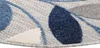 A close-up view of a round rug with a leaf pattern. Náhľad obrázku produktu