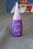 A purple bottle of Wella Creatine+ Curl hair product is shown against a gray, textured background. A blurred image of a person is visible in the background. Produktbild-Vorschau