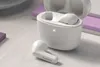 A white Philips in-ear earbud and its charging case are displayed on a textured surface. Podgląd zdjęcia produktu