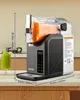 A slush machine filled with orange liquid is shown on a countertop, with a glass of green smoothie in the foreground. Produktbild-Vorschau