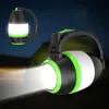 Two camping lanterns are shown in a dark outdoor setting, with one emitting a bright beam of light. Produktbild-Vorschau