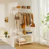 A white garment rack with clothes and storage baskets is in a room with a nightstand and a bed. Anteprima dell’immagine prodotto