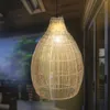A close-up shot of a woven pendant light hanging from a ceiling. Produktbild-Vorschau