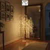 A lit willow tree decoration stands in a hallway next to a large mirror. Podgląd zdjęcia produktu