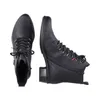 A pair of black leather boots shown from a top-down perspective, with one boot facing forward and the other facing to the side. Voir les images du produit