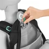 A hand is shown inserting a green component into a backpack. Náhled obrázku produktu