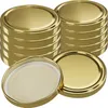 Stacks of gold-colored jar lids on a white background. Produktbild-Vorschau