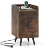 A rustic brown nightstand with two drawers and black metal legs, shown against a white background. A smartphone, a cup of coffee, and a watch are placed on top. Podgląd zdjęcia produktu
