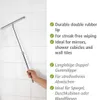 A hand holding a telescopic squeegee against a tiled wall. Produktbild-Vorschau