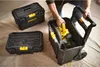 A person is placing a power tool into a rolling toolbox, with two other toolboxes nearby. Voir les images du produit