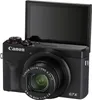 A black Canon PowerShot G7 X Mark III digital camera with its screen flipped up. Produktbild-Vorschau