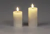 Two LED candles with flickering flames on a gray background. Produktbild-Vorschau