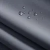 Close-up of a dark gray fabric with water droplets on it, showing its water-repellent properties. Produktbild-Vorschau