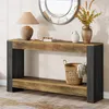 A console table with decorative items on top and a basket on the shelf below, placed in a room setting. Anteprima dell’immagine prodotto