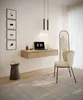 A modern home office setup with a floating desk, laptop, chair, and decorative items. Anteprima dell’immagine prodotto
