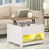A modern living room scene featuring a lift-top coffee table with storage, a laptop, and books. Produktbild-Vorschau