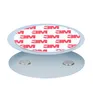 A product shot of two round, silver-colored discs, one stacked on top of the other. The top disc has a white sticker with red '3M' logos repeated across it. The bottom disc has two small, circular magnets embedded in it. Produktbild-Vorschau