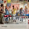 A group of young adults are playing a beer pong game at a table in a room with posters on the wall. Náhled obrázku produktu