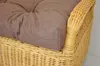 A close-up view of a cushion on a wicker chair. Produktbild-Vorschau