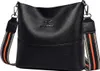 A black leather handbag with a striped strap is shown against a white background. Náhľad obrázku produktu