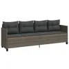 A long, four-seater outdoor sofa made of woven rattan with dark gray cushions, shown against a white background. Produktbild-Vorschau