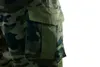 A close-up view of a camouflage cargo pocket on a pair of pants. Anteprima dell’immagine prodotto