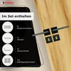 A set of door handles and accessories displayed on a black surface with a wooden background. Produktbild-Vorschau