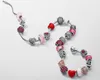 A collection of Pandora charms on a bracelet, displayed on a white background. Podgląd zdjęcia produktu