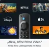 A collage of streaming service logos and movie posters surrounding a Fire TV remote, with a call to action at the bottom. Produktbild-Vorschau