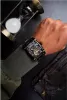 A man's arm wearing a watch is shown next to an hourglass and leather gloves. Náhled obrázku produktu