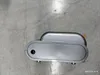 A top-down view of a silver-colored electronic device on a concrete floor. Produktbild-Vorschau