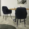 Two black velvet chairs at a round wooden dining table. Náhled obrázku produktu