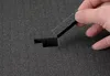 A hand is shown holding a piece of foam that is being removed from a larger piece of foam with a cut-out slot. Produktbild-Vorschau