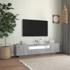 A modern living room with a TV stand, TV, plant, and rug. Anteprima dell’immagine prodotto