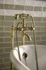 A close-up of a vintage-style bathtub faucet with a handheld showerhead, set against a tiled wall. Náhľad obrázku produktu