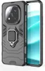 A dark gray protective phone case with a built-in ring holder is shown on the left, with the screen of a smartphone visible on the right. Náhled obrázku produktu