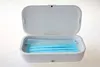 An open UV disinfection box with blue face masks inside. Produktbild-Vorschau
