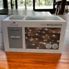 A product box for LED string lights is placed on a wooden table. Produktbild-Vorschau
