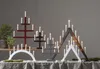A collection of wooden candle holders with lit candles. Produktbild-Vorschau