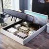 A bed with its storage compartment open, revealing storage boxes and suitcases inside. Náhled obrázku produktu