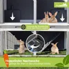 A multi-level rabbit hutch with rabbits inside, showing a feature for separating genders. Produktbild-Vorschau
