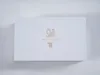 A white box with a gold logo and text. Podgląd zdjęcia produktu